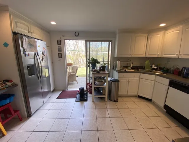 a kitchen with stainless steel appliances a refrigerator a sink a stove a microwave and cabinets