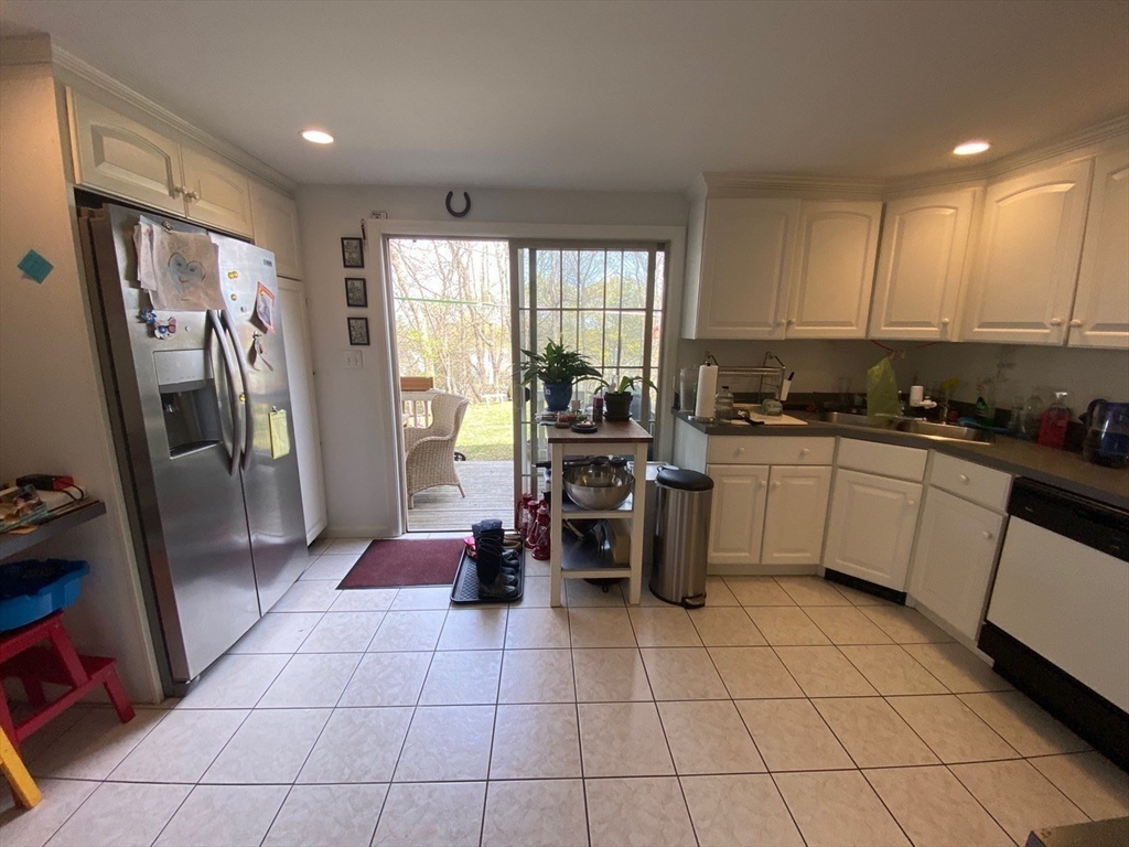 14 Park Place, Unit 14 Arlington, MA 02474 - Photo 4 of 20 a kitchen with stainless steel appliances a refrigerator a sink a stove a microwave and cabinets