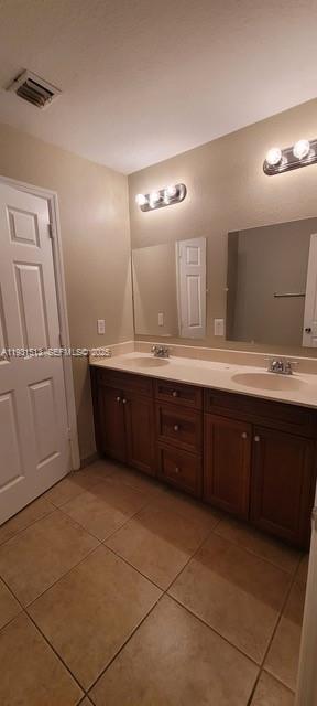 1400 Lucaya Drive Riviera Beach, FL 33404 - Photo 11 of 14 a spacious bathroom with a granite countertop sink a mirror and a vanity