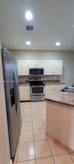 1400 Lucaya Drive Riviera Beach, FL 33404 - Photo 2 of 14 a kitchen with stainless steel appliances granite countertop a sink a stove a microwave and a refrigerator