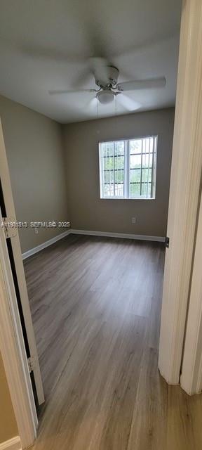 1400 Lucaya Drive Riviera Beach, FL 33404 - Photo 7 of 14 an empty room with wooden floor and windows