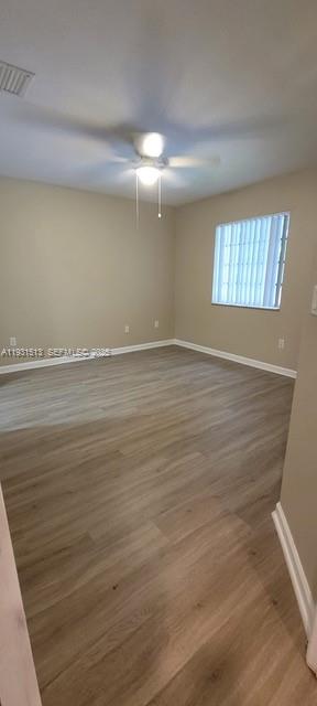 1400 Lucaya Drive Riviera Beach, FL 33404 - Photo 8 of 14 a view of an empty room with wooden floor