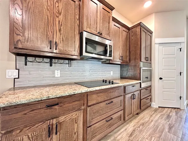 a spacious bathroom with a granite countertop sink and a large mirror