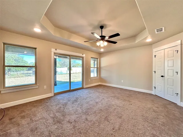 a spacious bathroom with a granite countertop sink and a mirror