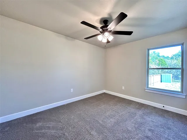 a bathroom with a granite countertop sink a toilet a mirror and bathtub