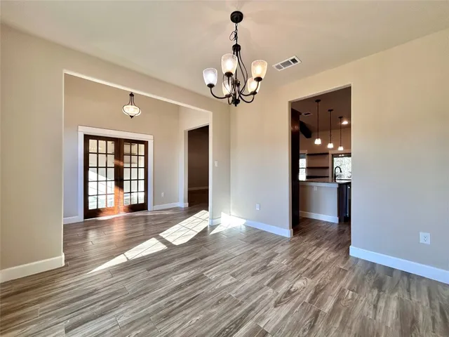 a kitchen with a counter space wooden floor and a ceiling fan