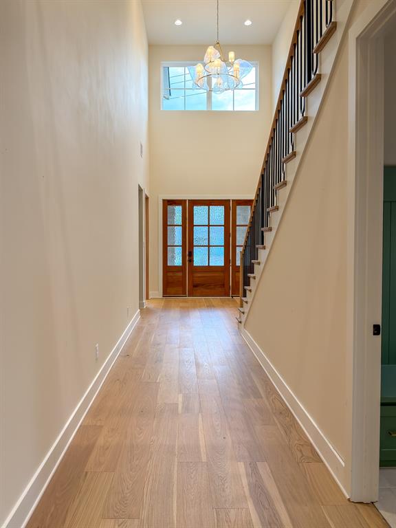 208 Pecan Street Roanoke, TX 76262 - Photo 11 of 38 wooden floor in an empty room with a chandelier