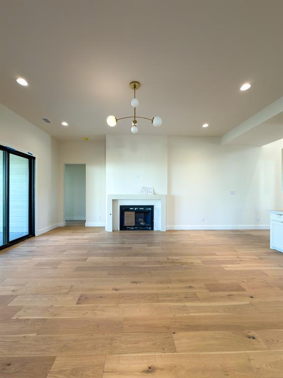 208 Pecan Street Roanoke, TX 76262 - Photo 12 of 38 a view of an empty room with a fireplace and a window