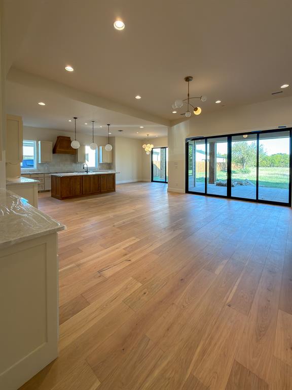 208 Pecan Street Roanoke, TX 76262 - Photo 13 of 38 a view of an empty room with kitchen and window
