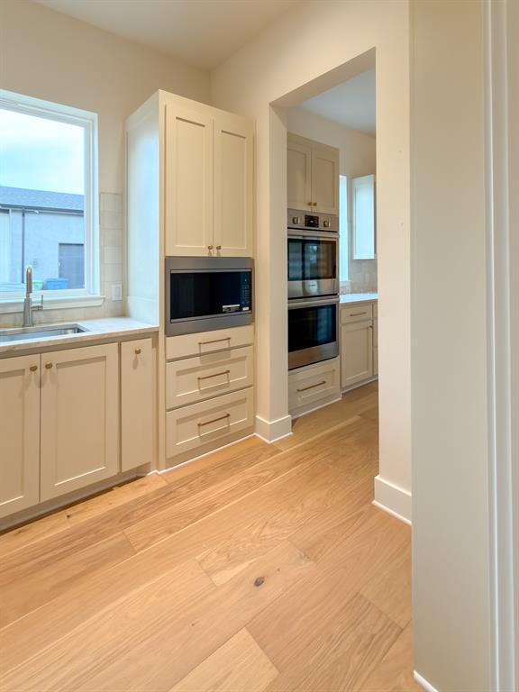 208 Pecan Street Roanoke, TX 76262 - Photo 19 of 38 a view of a kitchen with a sink and dishwasher oven kitchen view
