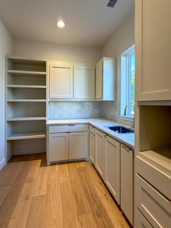 208 Pecan Street Roanoke, TX 76262 - Photo 20 of 38 a kitchen with a sink and wooden floor