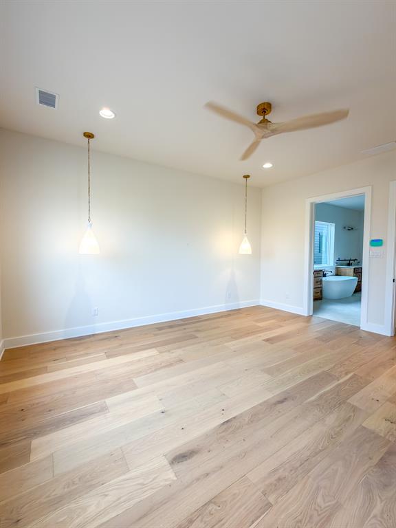 208 Pecan Street Roanoke, TX 76262 - Photo 24 of 38 a view of a room with a ceiling fan and wooden floor