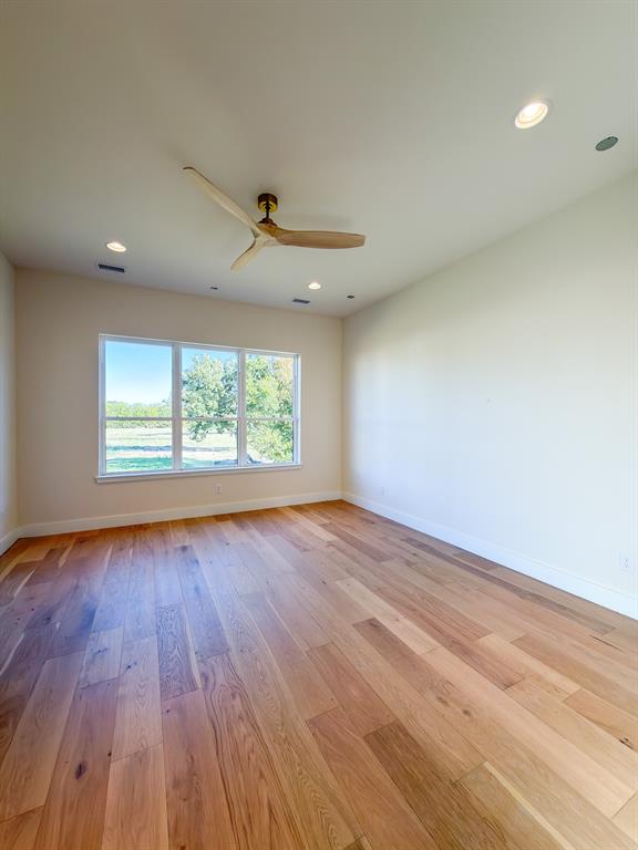 208 Pecan Street Roanoke, TX 76262 - Photo 25 of 38 an empty room with wooden floor and windows