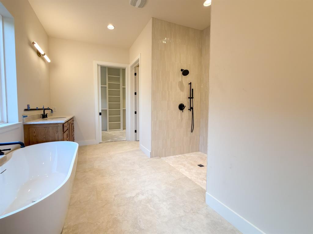 208 Pecan Street Roanoke, TX 76262 - Photo 26 of 38 a bathroom with a tub sink and mirror