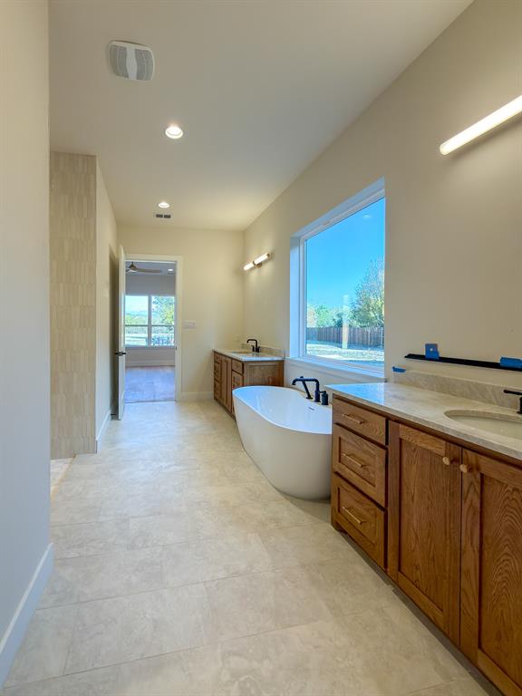 208 Pecan Street Roanoke, TX 76262 - Photo 27 of 38 a large bathroom with a large tub and sink