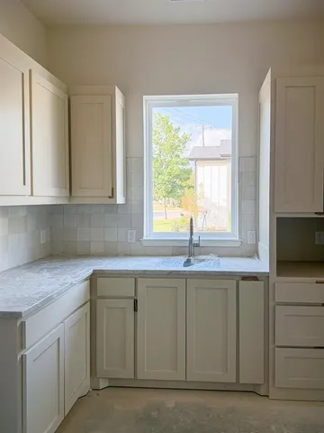 a kitchen with a sink and cabinets