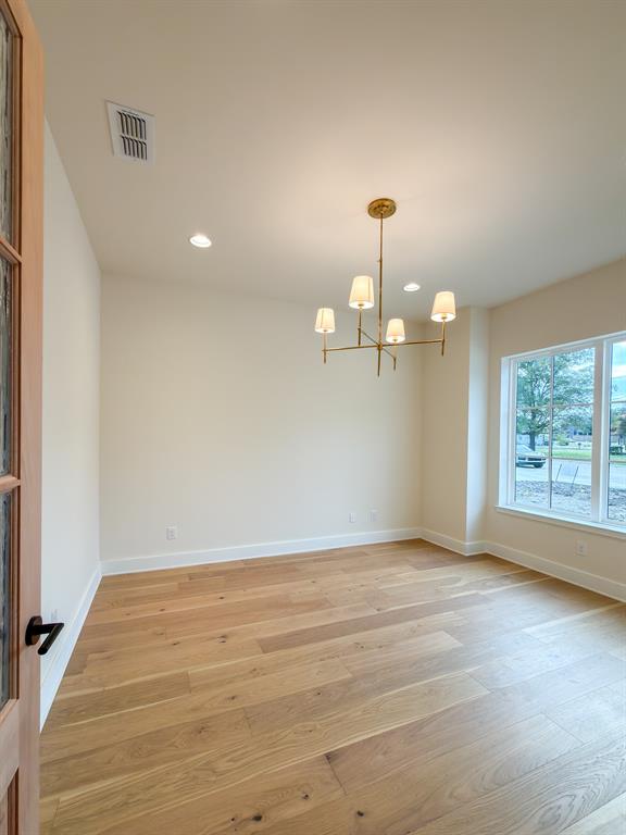 208 Pecan Street Roanoke, TX 76262 - Photo 8 of 38 wooden floor in an empty room with a window