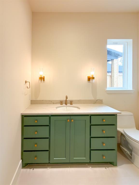 208 Pecan Street Roanoke, TX 76262 - Photo 9 of 38 a bathroom with a sink and a mirror