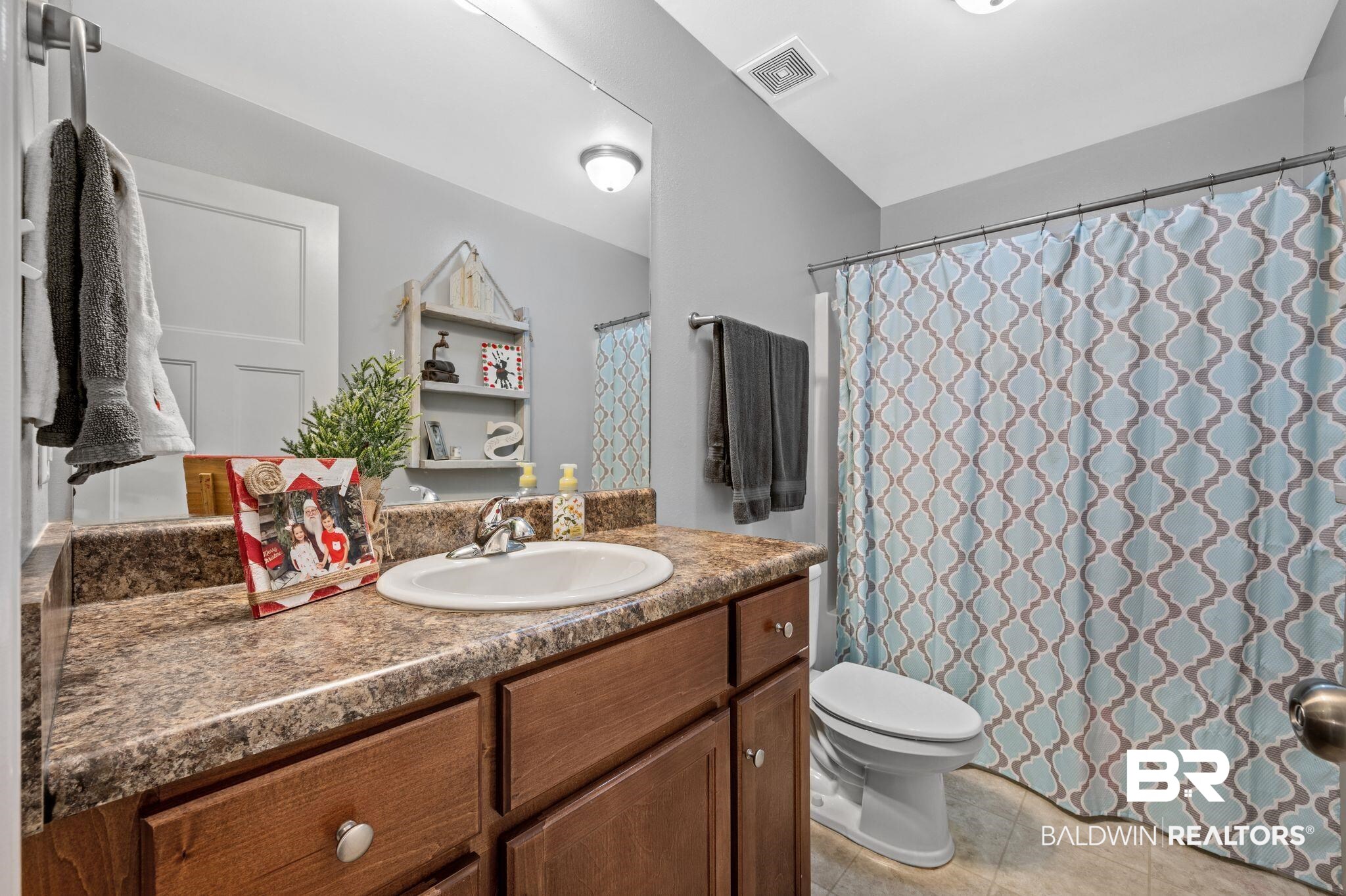 9366 Fox Run Court Semmes, AL 36575 - Photo 20 of 29 Bathroom with tile patterned floors, vanity, and toilet