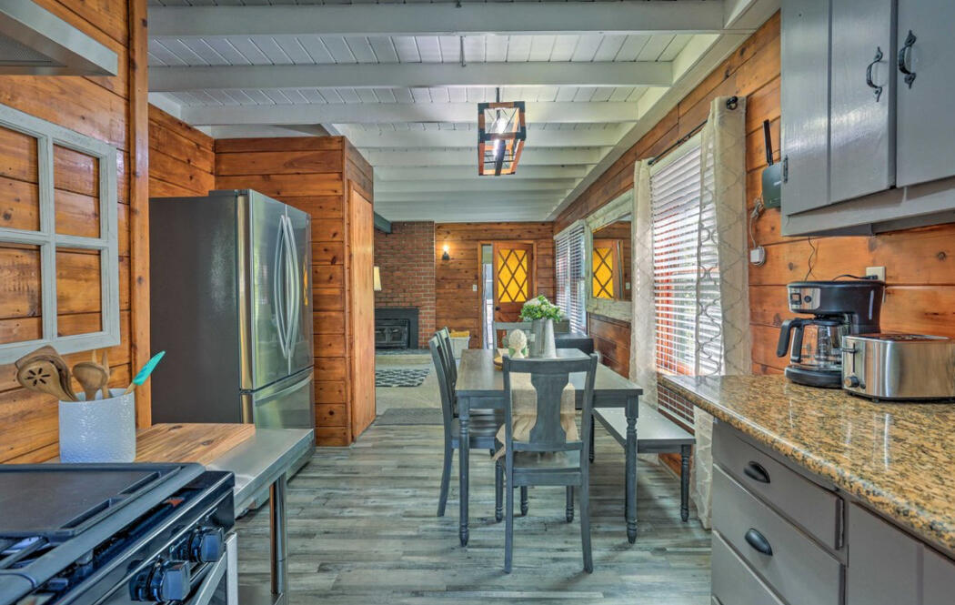 42036 Tollhouse Road Shaver Lake, CA 93664 - Photo 4 of 30 a kitchen with stainless steel appliances granite countertop a table chairs and a refrigerator