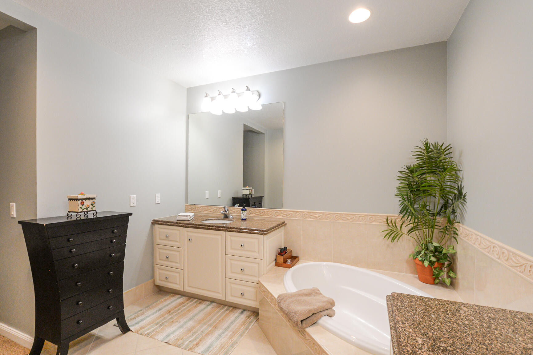 35 Harbour Isle Drive West, Unit 302 Fort Pierce, FL 34949 - Photo 14 of 30 a spacious bathroom with a double vanity sink and a mirror