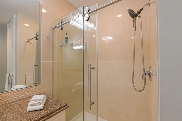 a bathroom that has a glass shower door