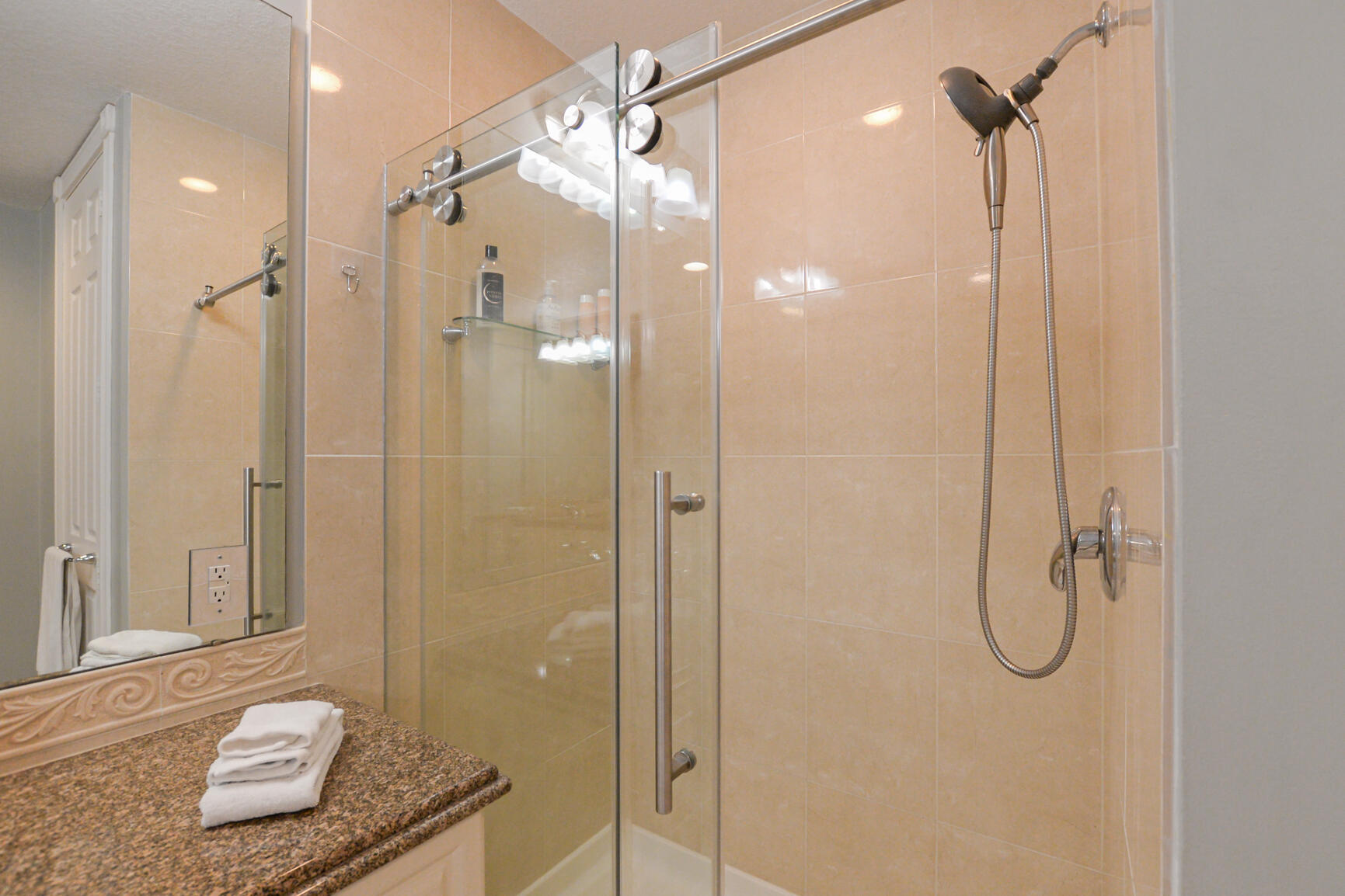 35 Harbour Isle Drive West, Unit 302 Fort Pierce, FL 34949 - Photo 15 of 30 a bathroom that has a glass shower door