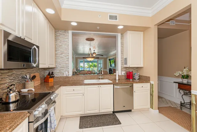 a kitchen that has a sink and a stove in it