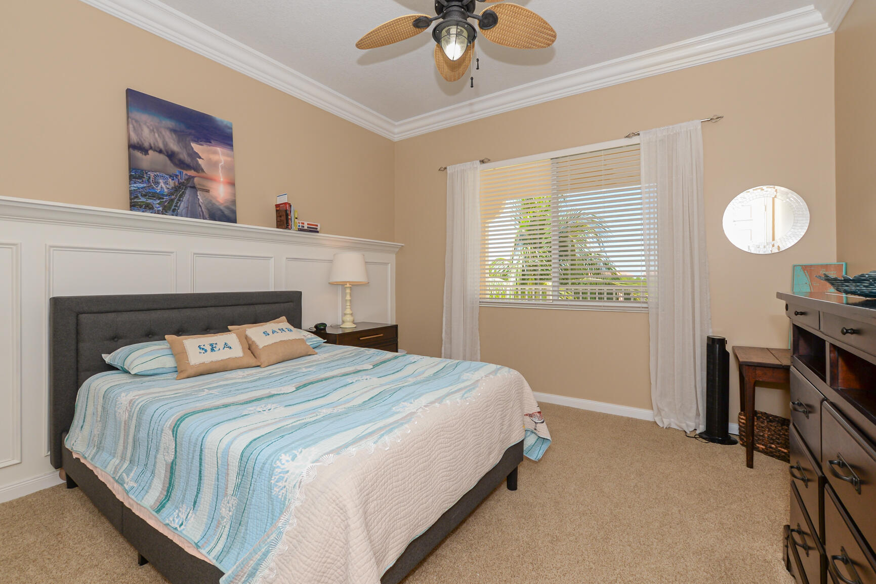 35 Harbour Isle Drive West, Unit 302 Fort Pierce, FL 34949 - Photo 17 of 30 a bedroom with a bed and a chandelier