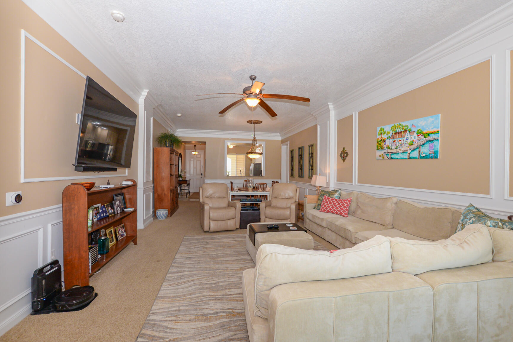 35 Harbour Isle Drive West, Unit 302 Fort Pierce, FL 34949 - Photo 6 of 30 a living room with furniture and a flat screen tv