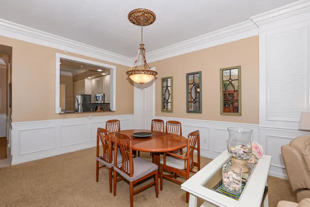 a view of a dining room with furniture and a chandelier