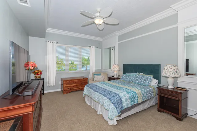 a bedroom with a bed and a chandelier