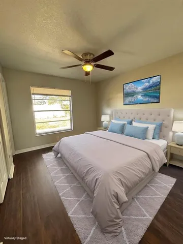 a bedroom with a large bed and a window