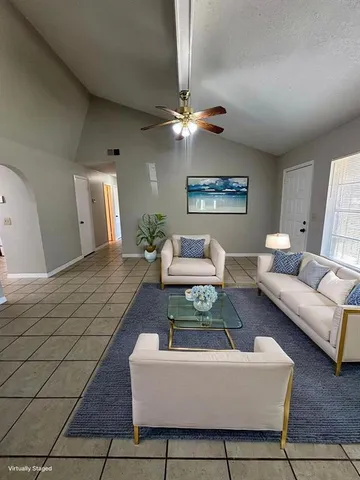 a living room with furniture a rug and a chandelier