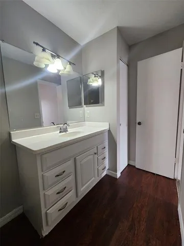 a bathroom with a double vanity sink and a mirror