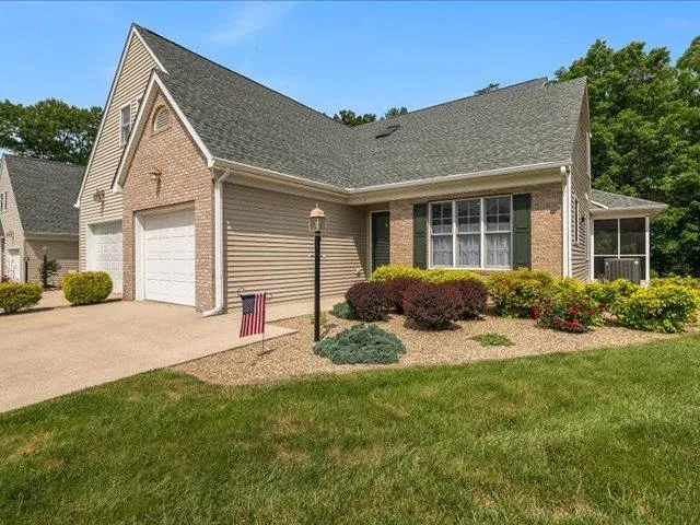 a view of a house with backyard and a tree