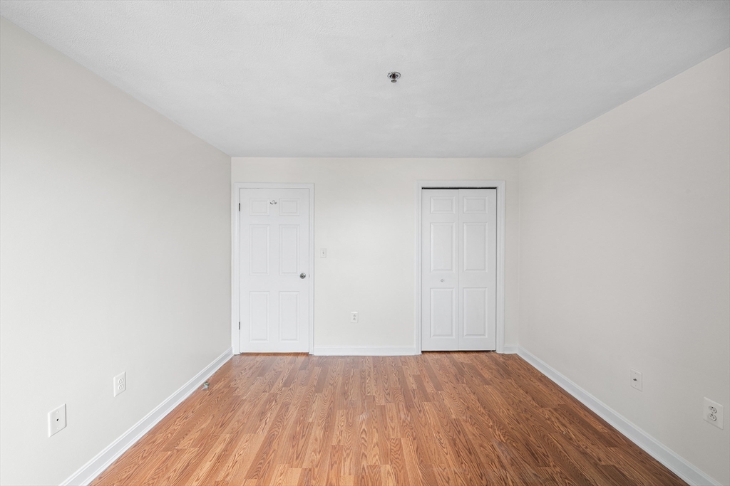 39 Parlin Street, Unit 503 Everett, MA 02149 - Photo 15 of 24 a view of an empty room with wooden floor