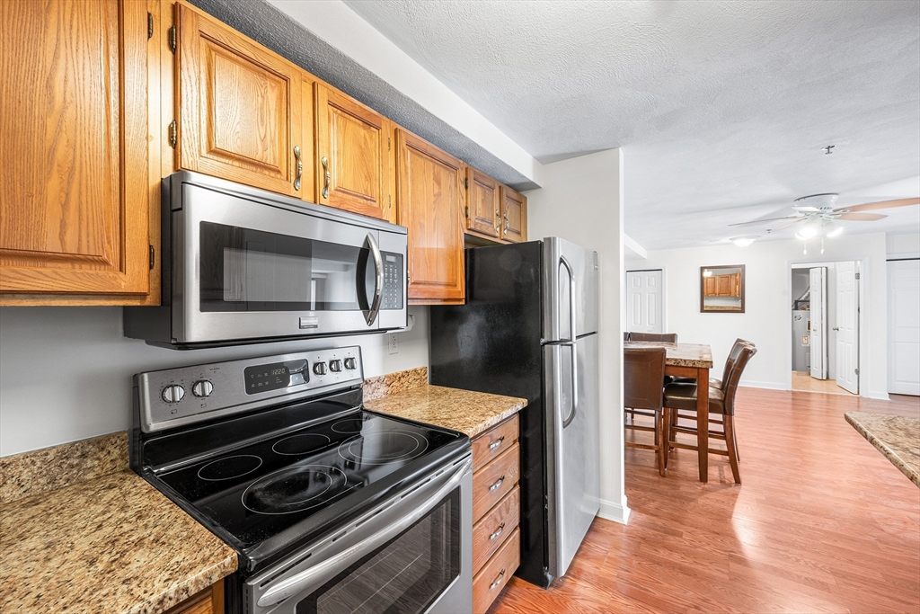 39 Parlin Street, Unit 503 Everett, MA 02149 - Photo 7 of 24 a kitchen with stainless steel appliances granite countertop a stove a refrigerator and a microwave