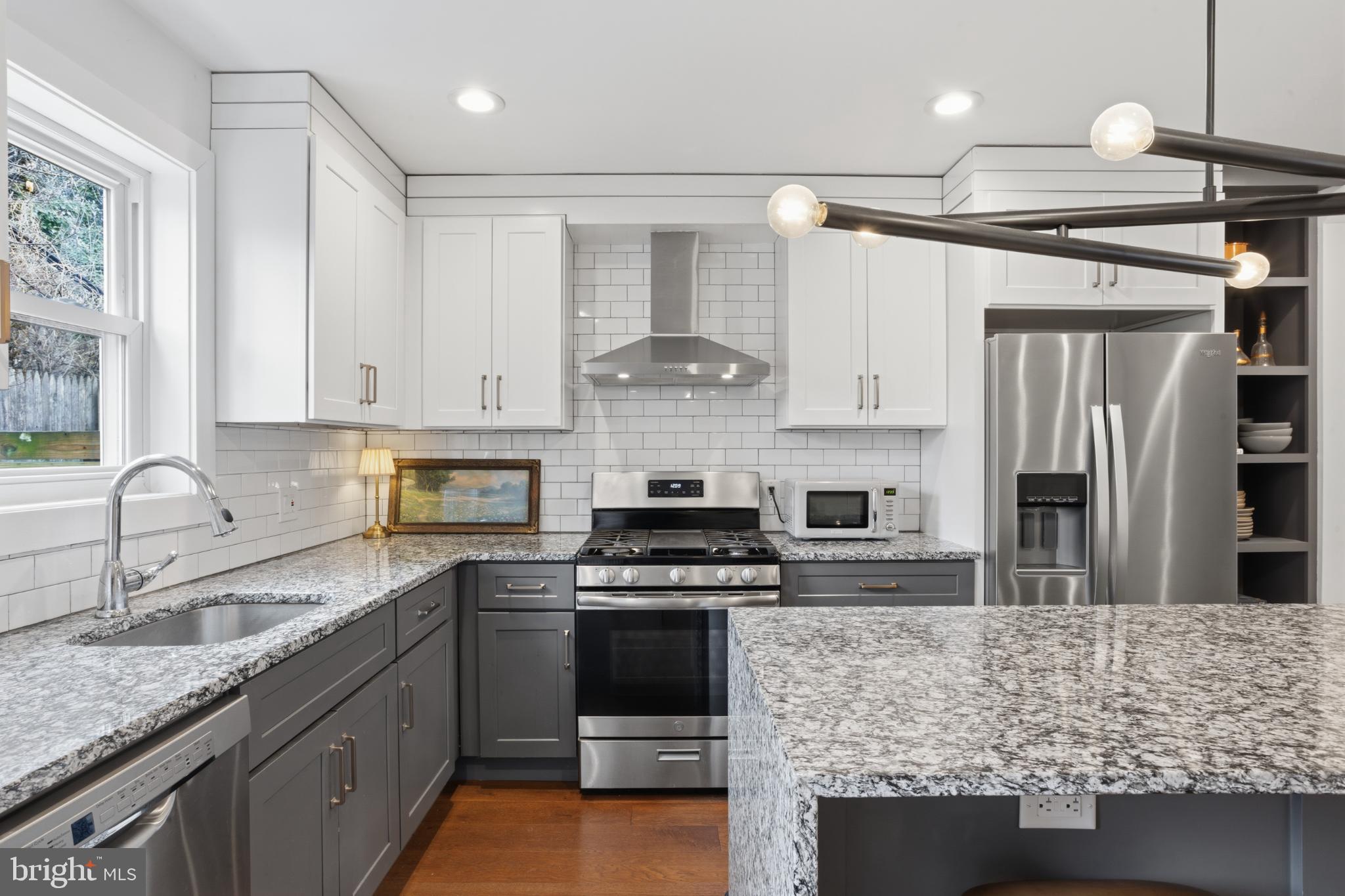 173 West Price Street Philadelphia, PA 19144 - Photo 13 of 40 a kitchen with stainless steel appliances granite countertop a stove and a sink
