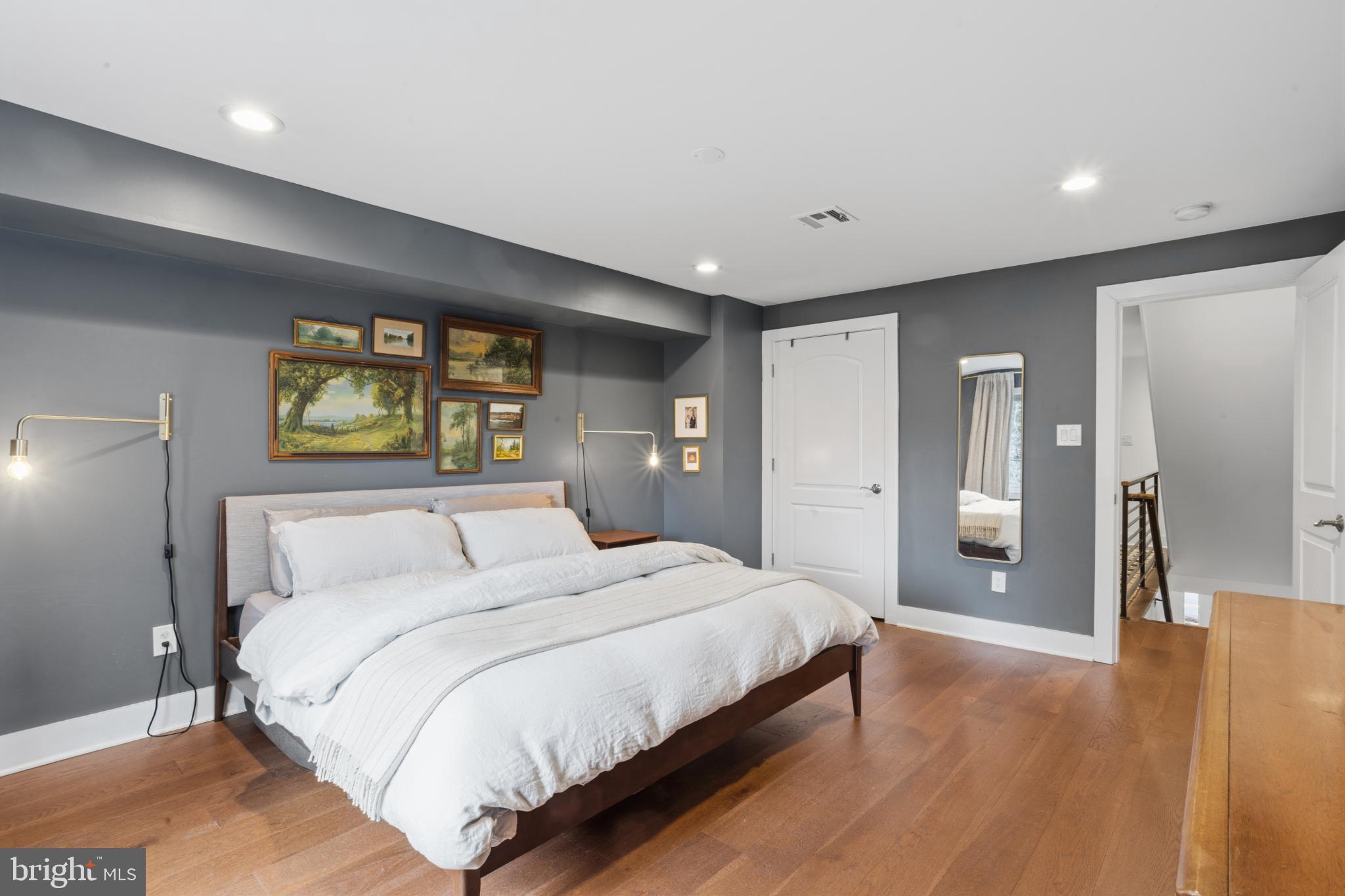173 West Price Street Philadelphia, PA 19144 - Photo 16 of 40 a bedroom with a large bed and a chandelier