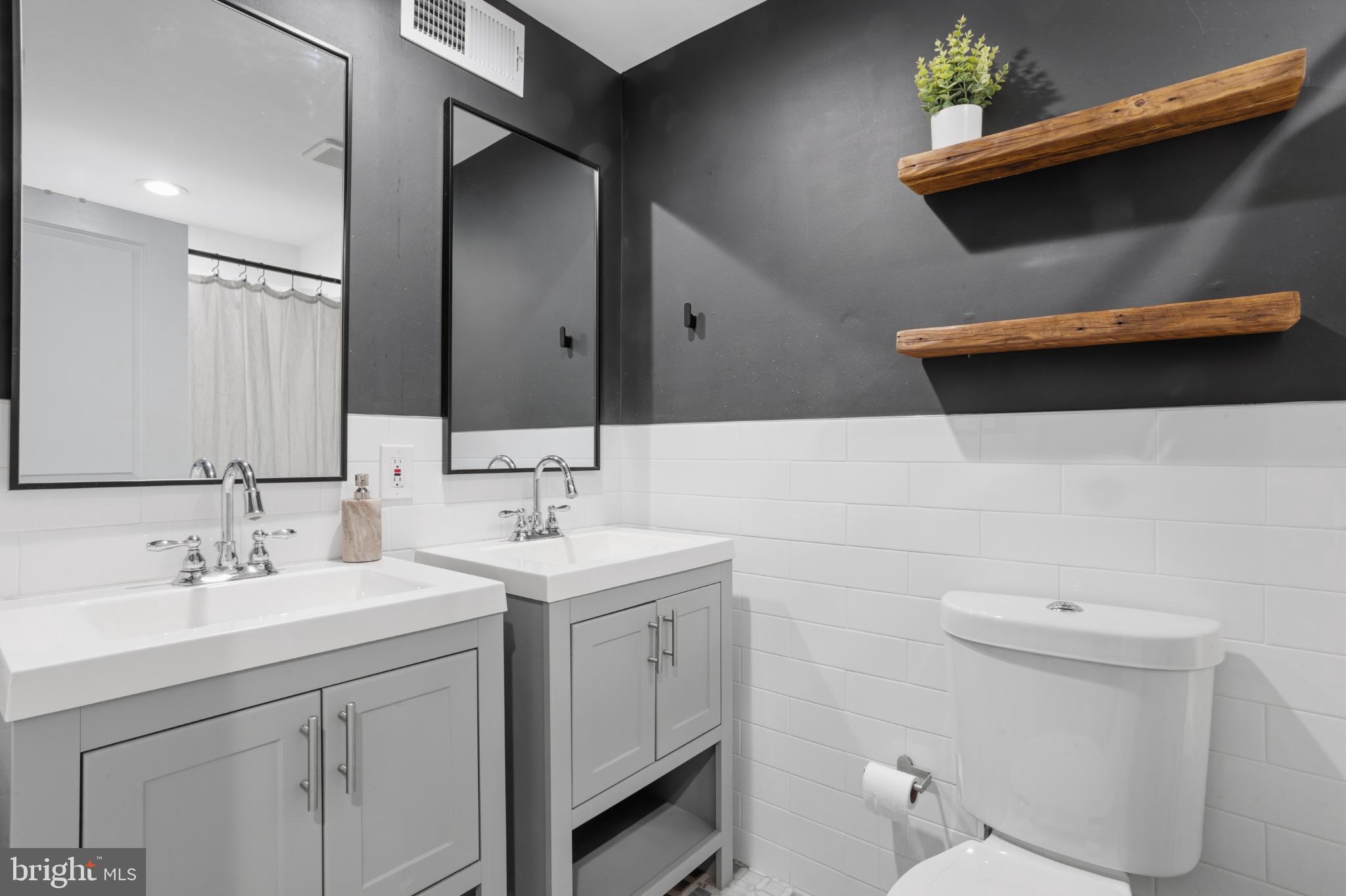 173 West Price Street Philadelphia, PA 19144 - Photo 19 of 40 a bathroom with a sink a toilet and mirror