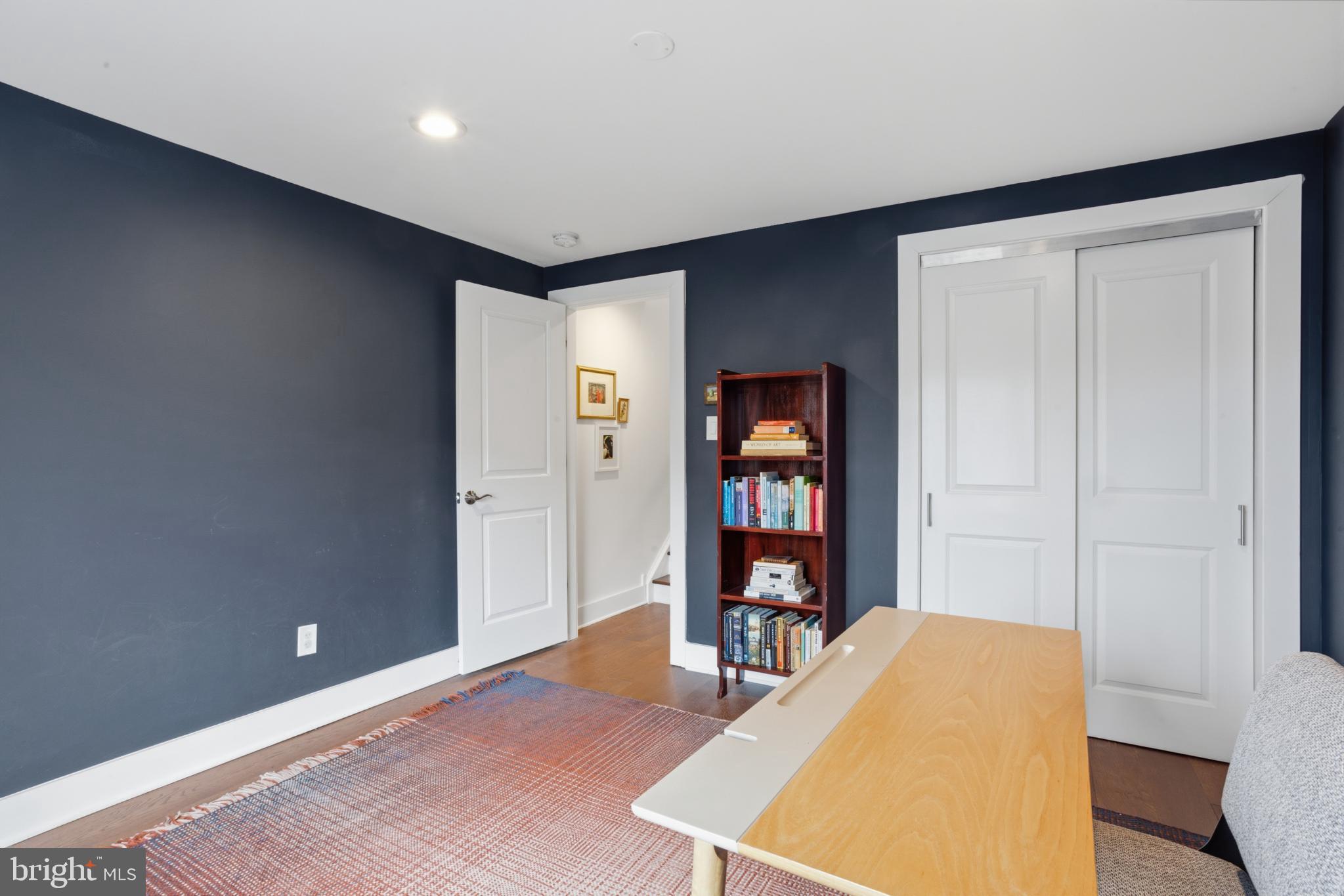 173 West Price Street Philadelphia, PA 19144 - Photo 23 of 40 a living room with a bookshelf and a wooden floor