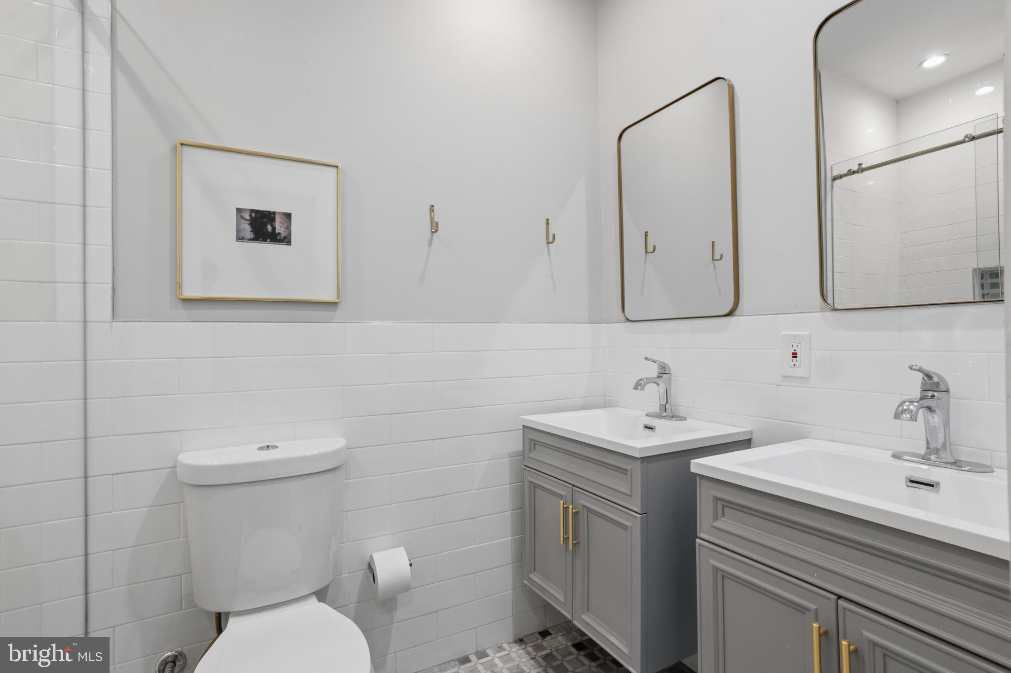173 West Price Street Philadelphia, PA 19144 - Photo 28 of 40 a bathroom with a toilet sink and mirror
