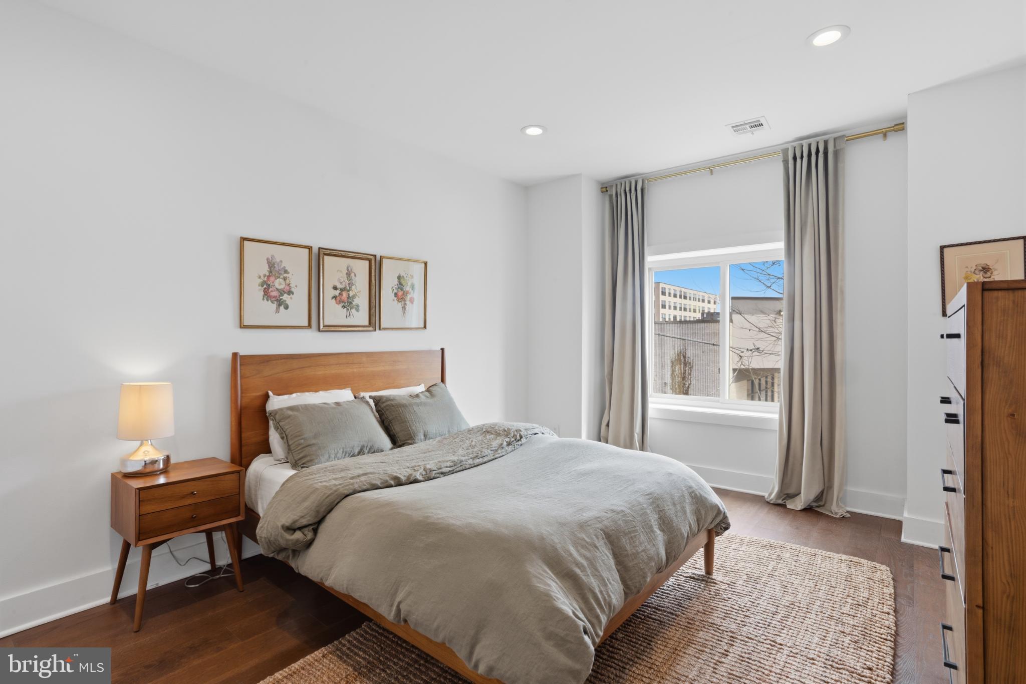173 West Price Street Philadelphia, PA 19144 - Photo 31 of 40 a bedroom with a bed and a night stand