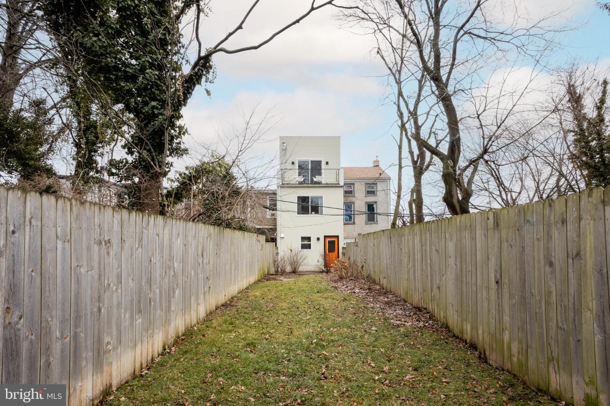 173 West Price Street Philadelphia, PA 19144 - Photo 36 of 40 a view of a house with a wooden fence