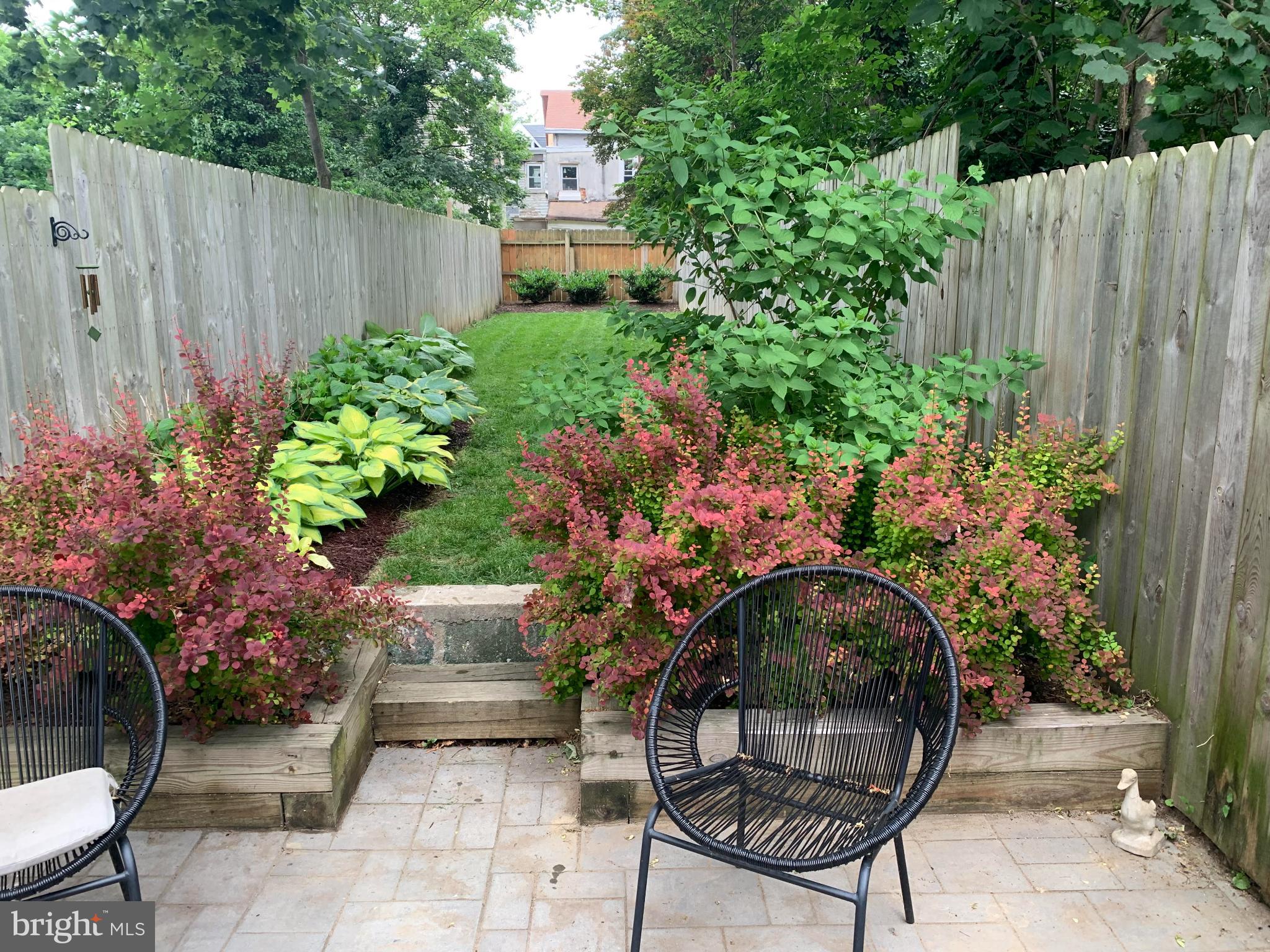 173 West Price Street Philadelphia, PA 19144 - Photo 37 of 40 a backyard with potted plants and a bench