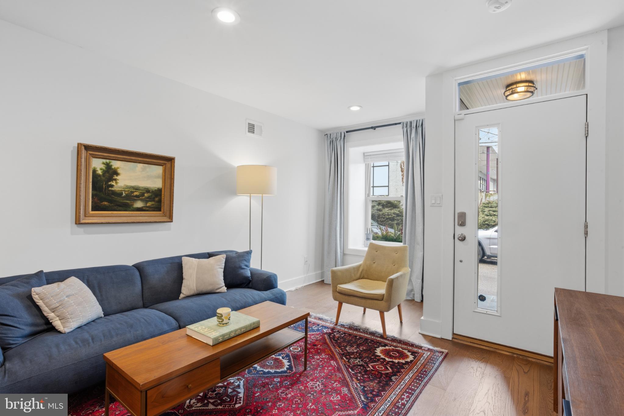 173 West Price Street Philadelphia, PA 19144 - Photo 8 of 40 a living room with furniture and a window with wooden floor