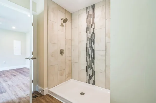 a bathroom with a tub and shower