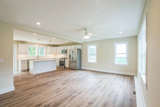 a view of a kitchen with a sink cabinets and wooden floor