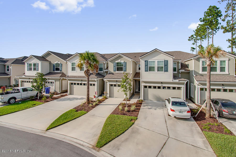 122 Nelson Lane St. Johns, FL 32259 - Photo 1 of 33 a front view of a house with a garden and plants